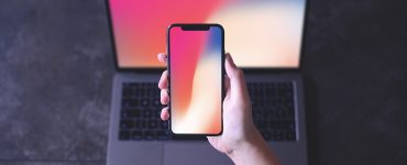Free iPhone X in Hand Mockup PSD