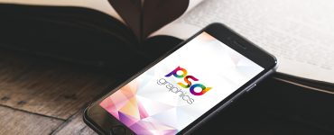 iPhone on Wooden Table Mockup Free PSD