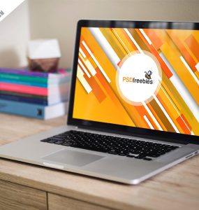 Macbook Pro on Wooden Table Mockup PSD