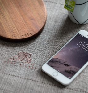 White iPhone 6 on Table Mockup Free PSD
