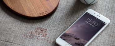 White iPhone 6 on Table Mockup Free PSD