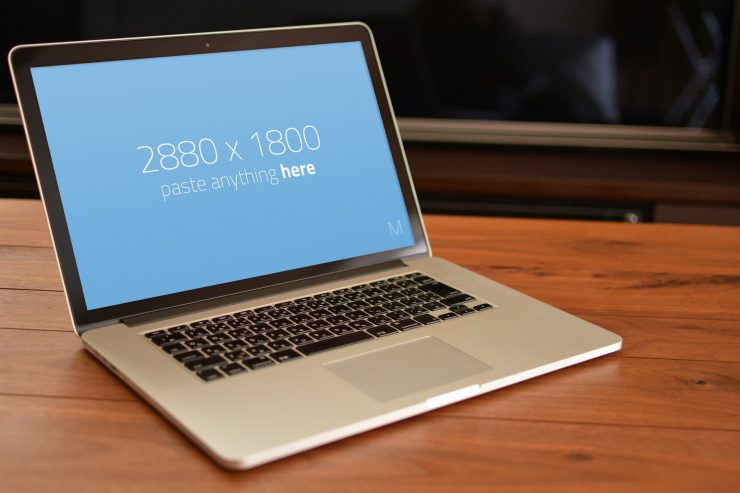 Macbook Pro on wooden table Mockup Free PSD