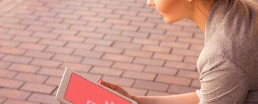 iPad in Hand Photorealistic Mockup Free PSD